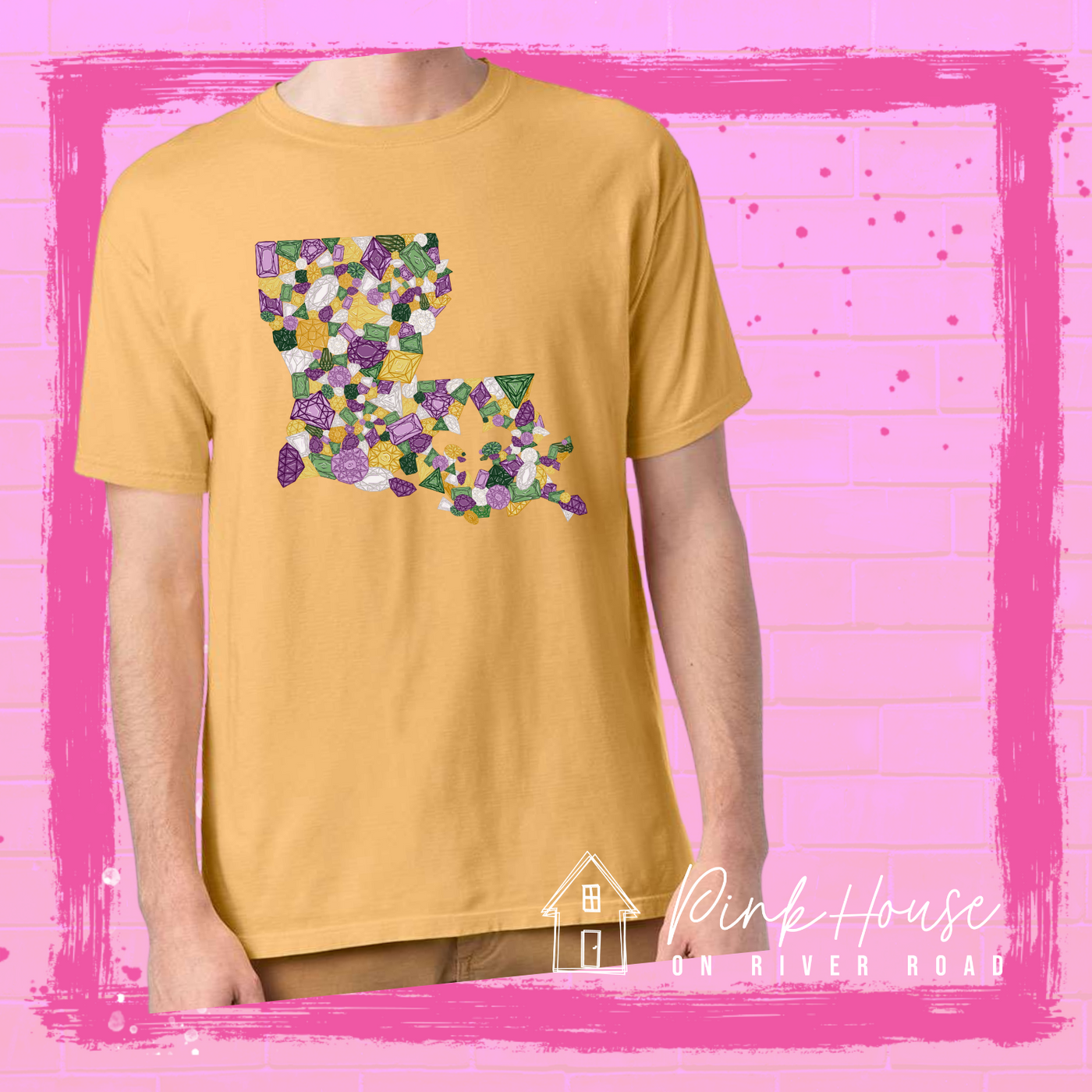 Mustard tee with a graphic of the state of Louisiana compromised of different shapes and sizes of purple, green, yellow and clear jewels.