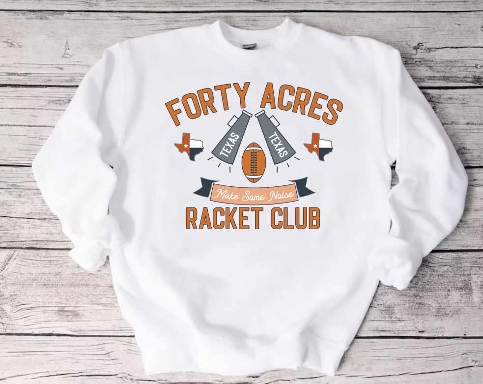 White Crew Neck Sweatshirt on a Wood Background. Sweatshirt has art that says ""Forty Acres Racket Club"  the art also has a banner that says make some noise with a football, two megaphones that say Texas and two Texas Graphics.