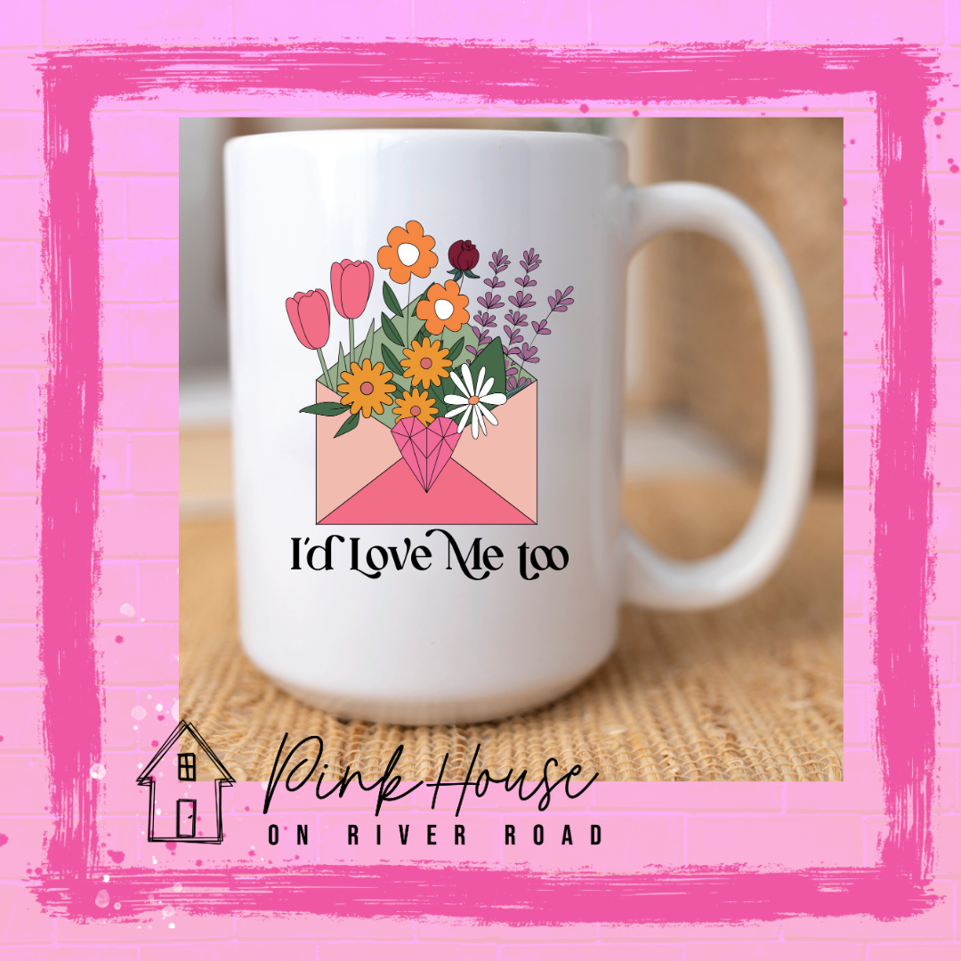 A white coffee mug with a graphic of an envelope filled with different types of flowers and a geometric heart seal. the text underneath reads I'd Love Me Too