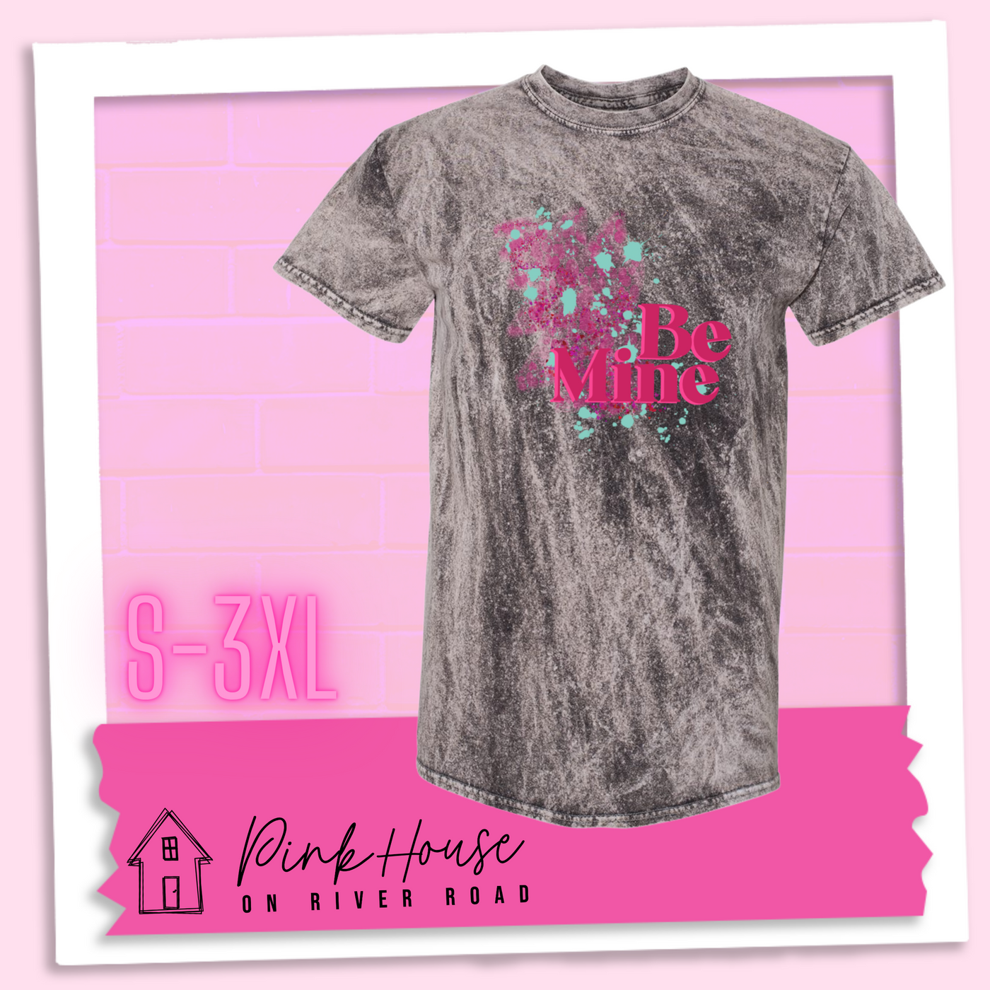 Charcoal Mineral Wash Tee with a squiggle design made of pink hearts and pink sparkles with light teal splatters and pink text at the end of the art that says Be Mine with a hot pink shadow.