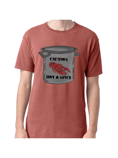 Nantucket Red T shirt with a graphic of a large stainless steel pot, on the pot at the top is the word Caution with a crawfish below and the words Hot & Spicy underneath
