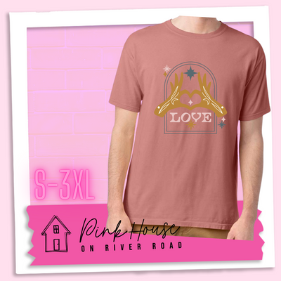 Mauve tee with a graphic. Graphic is of two tattooed hands making a heart in front of an archway with stars and the word Love in the archway.