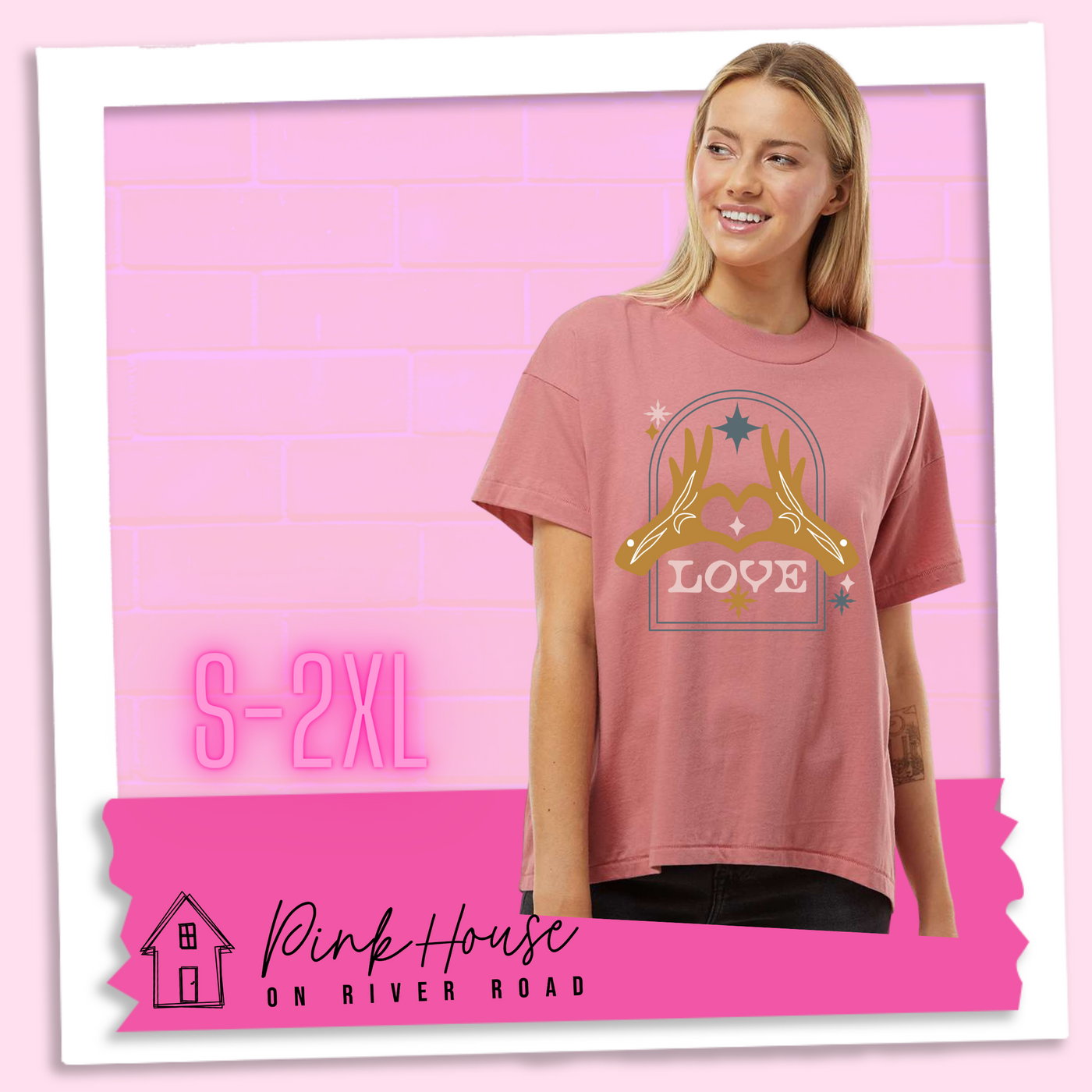 Blonde model wearing a Mauve oversized HiLo Shirt with a graphic. Graphic is of two tattooed hands making a heart in front of an archway with stars and the word Love in the archway.