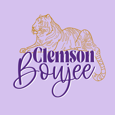 Light purple background with a gold line drawing tiger laying on top of the words Clemson Boujee. The text is purple with a white shadow and the word boujee is in cursive