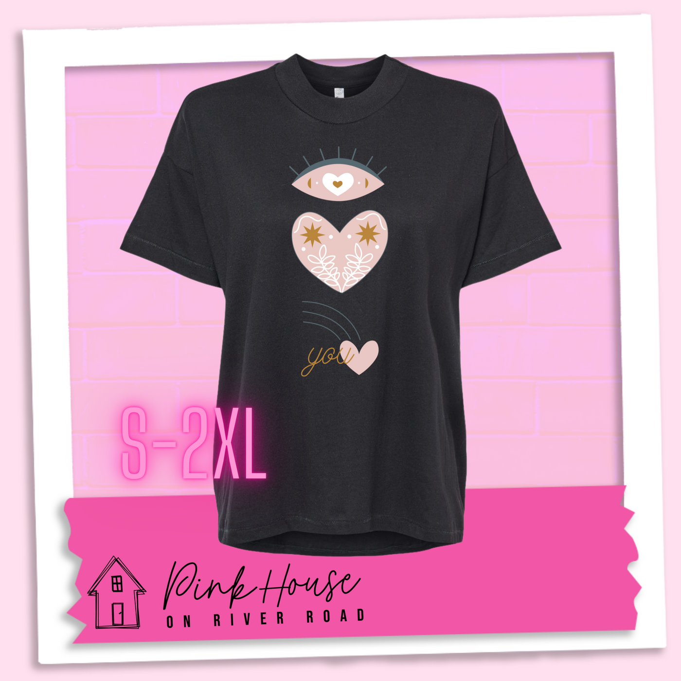Black oversized HiLo tee with the graphic of an eye with a heart for the pupil and underneath that a heart with a floral and star design and a shooting heart with the word you. The graphic represents eye heart you