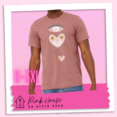 Heather mauve tee with a graphic of an eye with a heart for the pupil and underneath that a heart with a floral and star design and a shooting heart with the word you. The graphic represents eye heart you