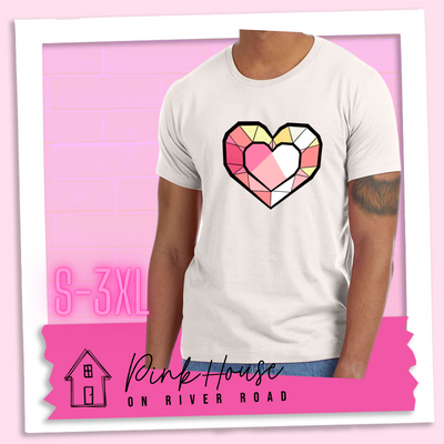 Dust graphic tee. the graphic is of a geometric heart, it has black outlines to make it look like a gem with different shades of pinks, yellows, and white.