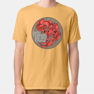 Heather Mustard Tee. Graphic is a grey plate full of crawfish and the words "Hello Crawfish My Old Friend" In a white font towards the bottom left of the plate