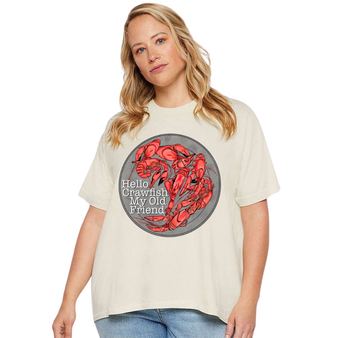 Oversized Cream HiLo Tee. Graphic is a grey plate full of crawfish and the words "Hello Crawfish My Old Friend" In a white font towards the bottom left of the plate