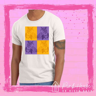 A Dust tee with a pop art graphic. The graphic has a square compromised of four smaller squares. The top left is a yellow square with a yellow tiger and the top right is a purple square with a purple tiger, on the bottom left is a purple square with a purple tiger and on the bottom right there is a yellow square with a yellow tiger