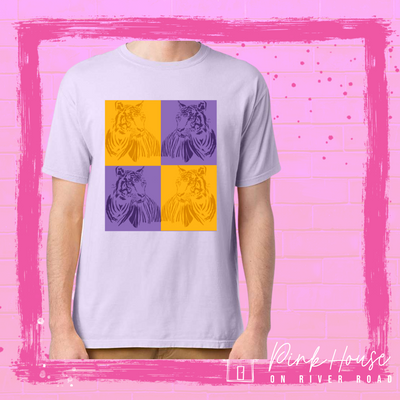 Lavender Tee with a pop art graphic. The graphic has a square compromised of four smaller squares. The top left is a yellow square with a yellow tiger and the top right is a purple square with a purple tiger, on the bottom left is a purple square with a purple tiger and on the bottom right there is a yellow square with a yellow tiger