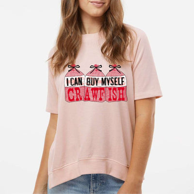 Peach French Terry Tee. Graphic is 3 bags of crawfish lined up next to each other. The labels read "I Can Buy Myself" and the word "Crawfish" In red on the bags under the labels
