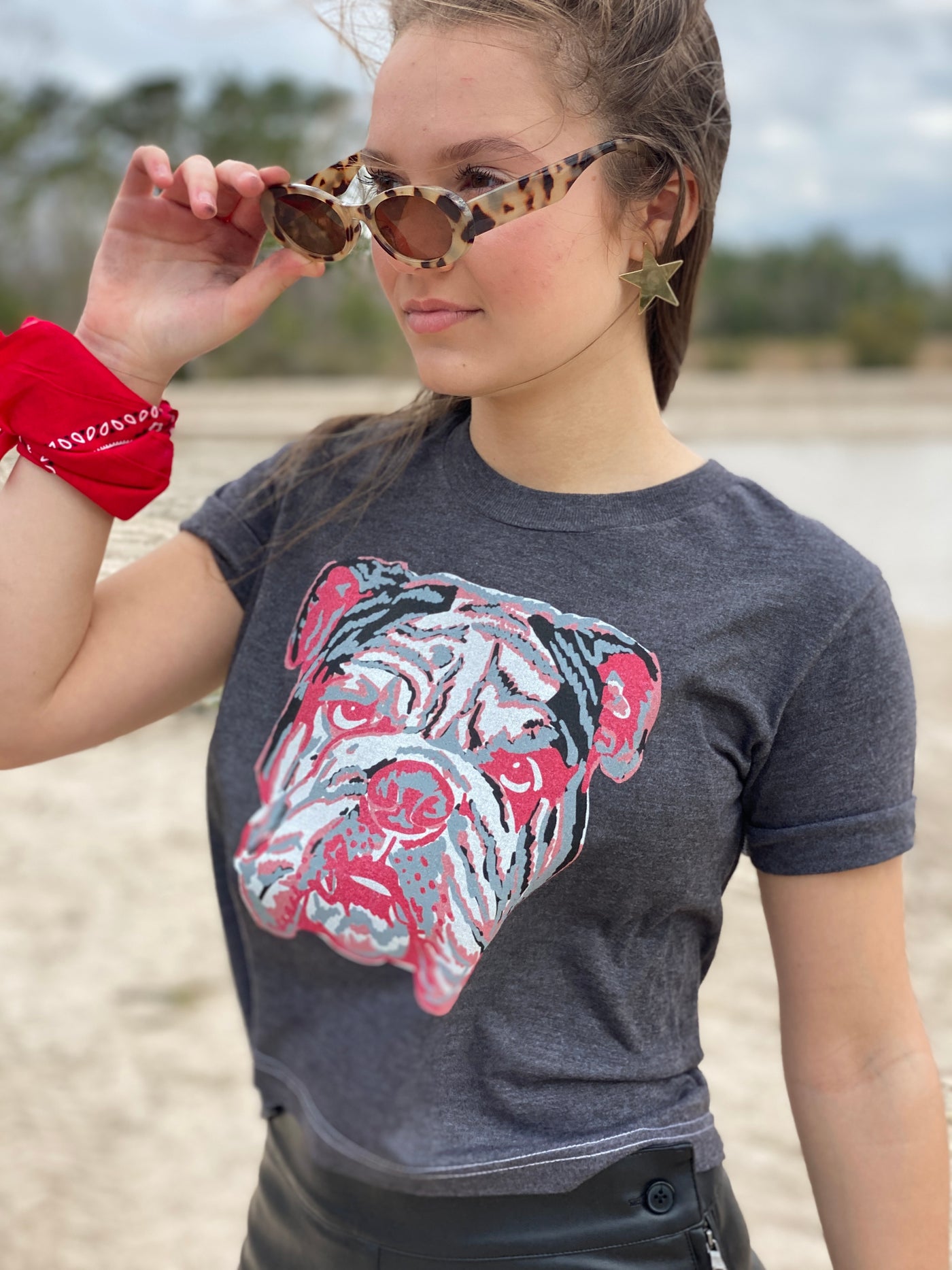 A black tee with a graphic of a red white and grey layered bulldog
