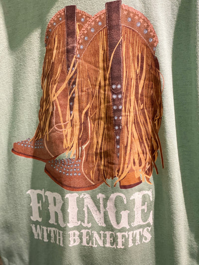 Green tee with graphic. The graphic on the tee is a pair of cowboy boots adorned with rhinestones and fringe and the words fringe with benefits in a western font under the boots.