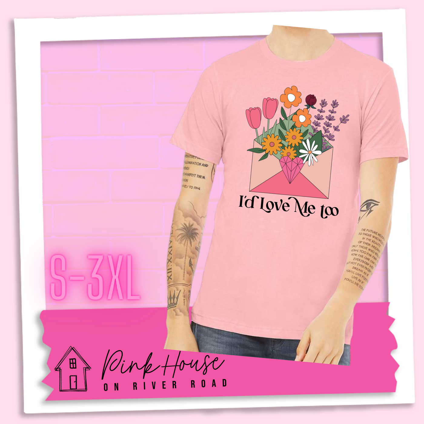 Pink tee with a graphic of a pink envelope filled with different types of flowers and a geometric heart seal. The text underneath reads "I'd Love Me Too"