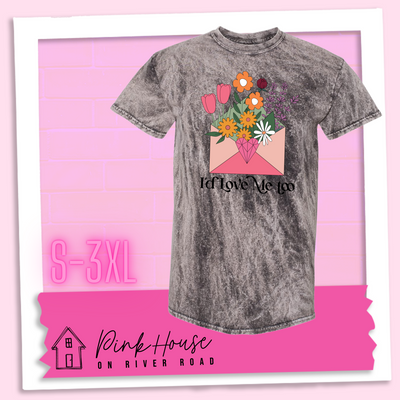 Charcoal Mineral Wash tee with a graphic of a pink envelope filled with different types of flowers and a geometric heart seal. The text underneath reads "I'd Love Me Too"