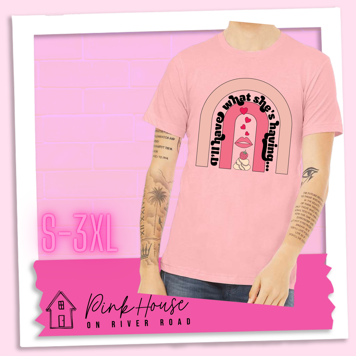 Pink tee with a graphic of a strawberry dessert and a set of lips with hearts, there is a pink arch going over the art. There is a retro font arched over the pink art that says "I'll have what she's having..." in black with another arch above that in light pink.