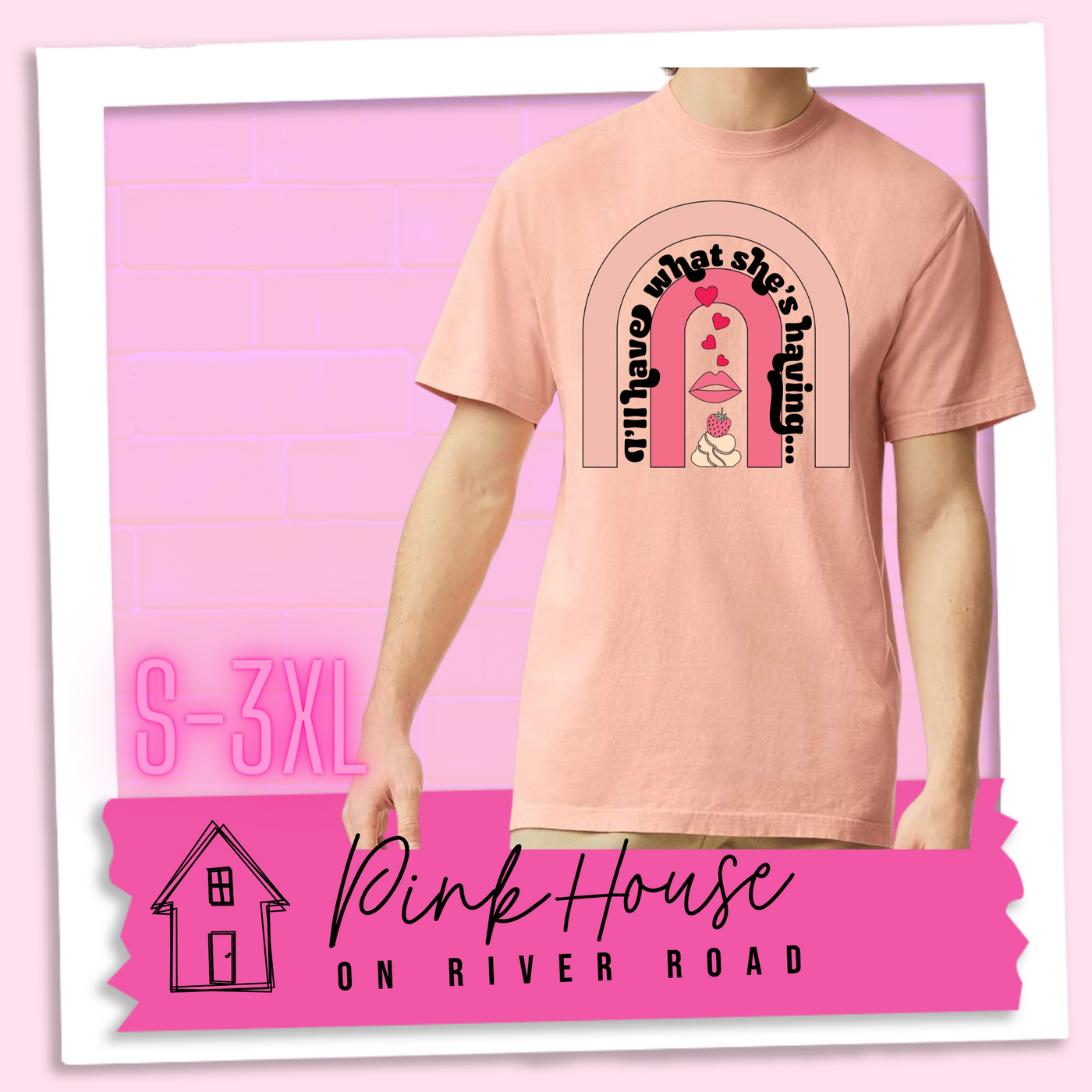 Peach tee with a graphic of a strawberry dessert and a set of lips with hearts, there is a pink arch going over the art. There is a retro font arched over the pink art that says "I'll have what she's having..." in black with another arch above that in light pink.