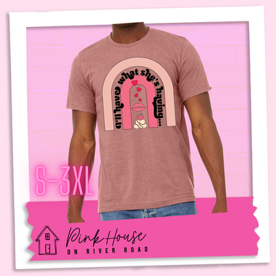 Heather mauve tee with a graphic of a strawberry dessert and a set of lips with hearts, there is a pink arch going over the art. There is a retro font arched over the pink art that says "I'll have what she's having..." in black with another arch above that in light pink.