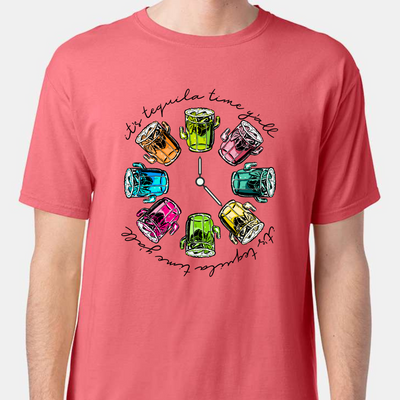 Coral tee with a graphic. Graphic has a clock in the center with multicolored margaritas instead of numbers and around the outside of the clock are the words "It's tequila time y'all" in black cursive font.
