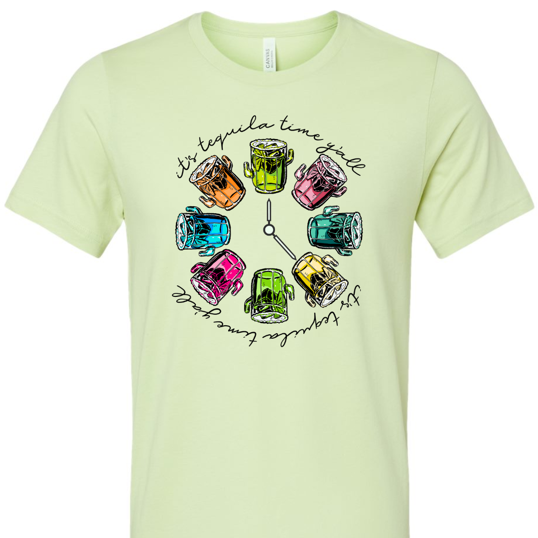 Spring Green tee with a graphic. Graphic has a clock in the center with multicolored margaritas instead of numbers and around the outside of the clock are the words "It's tequila time y'all" in black cursive font.