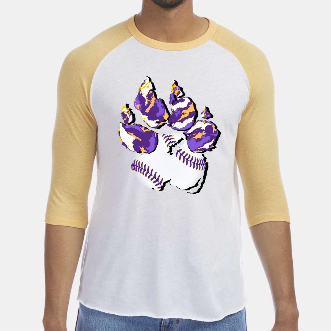 Maize and White Raglan. Graphic of a paw print, the pad of the paw is baseball print with purple laces and the toe pads are abstract purple, yellow, and white print.
