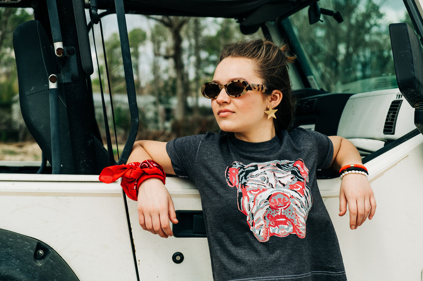 A black tee with a graphic of a red white and grey layered bulldog