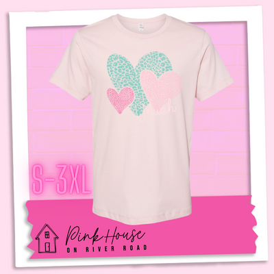 Faded Pink tee with 3 different colored leopard print hearts in various sizes in the lower right hand corner of the graphic is the word Muah in light punk script