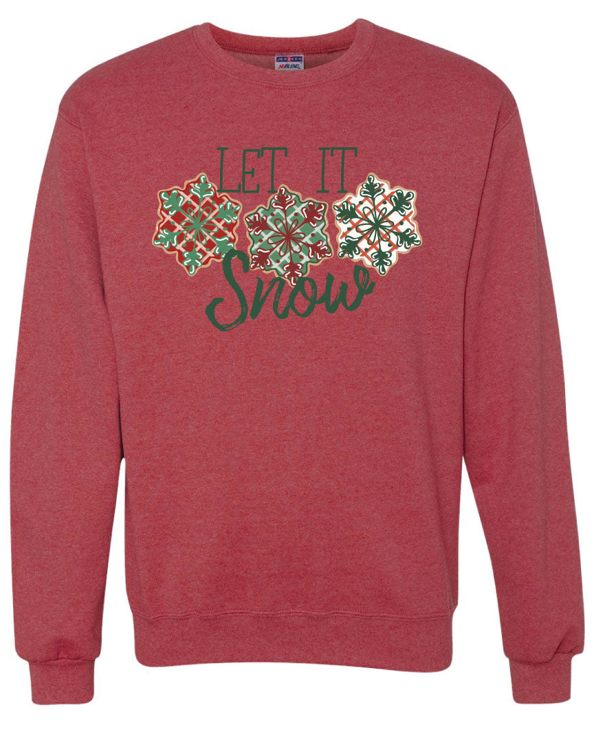Red Sweatshirt with the words Let It in think block letters at the top with three snowflakes underneath. Far left snowflake is red with beige stripes and a green snowflake design on the top, Middle snowflake is green with white stripes and a dark red snowflake design on the top, and the right snowflake is white with red stripes and a dark green snow flake design on top and the word snow in a brush script underneath.