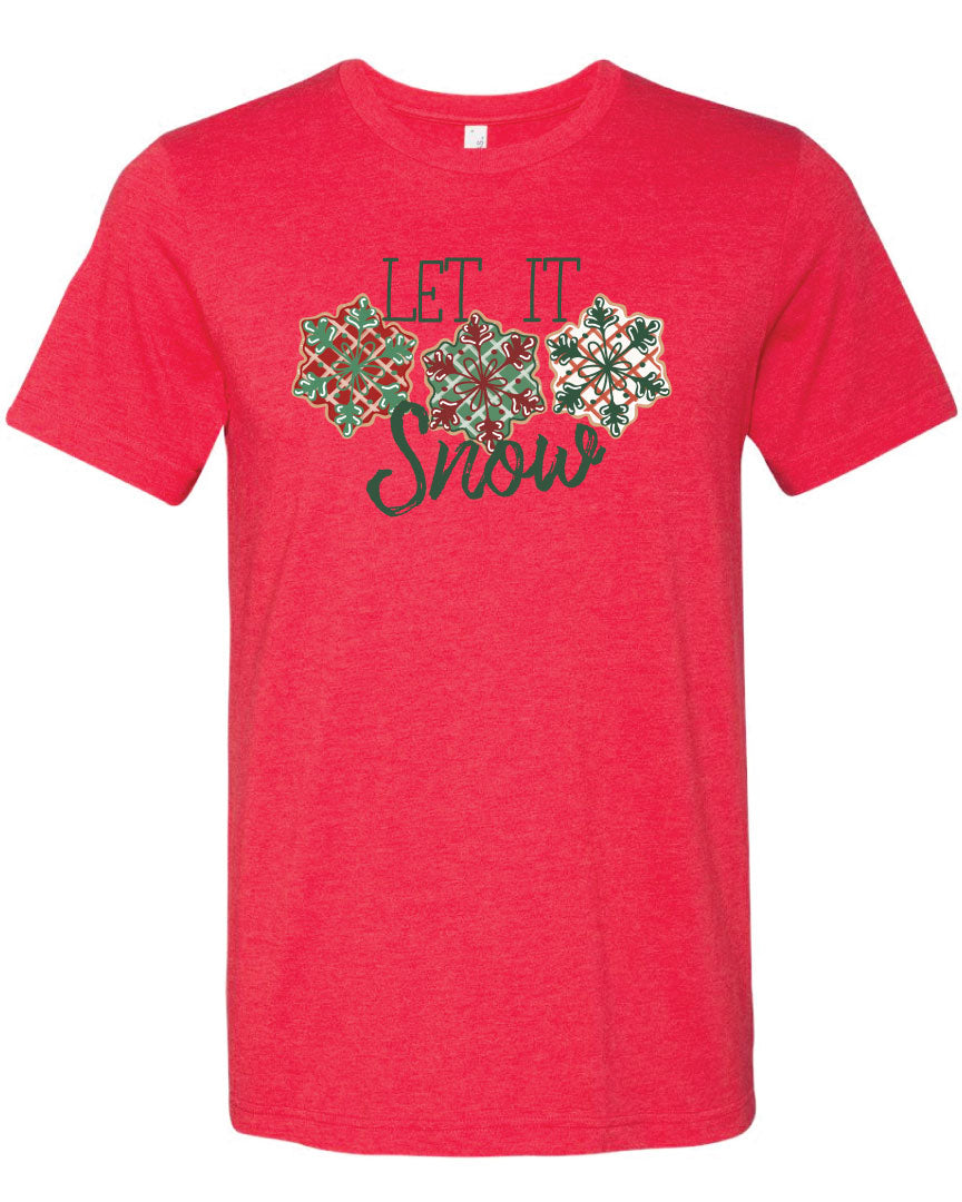 Red tee with the words Let It in think block letters at the top with three snowflakes underneath. Far left snowflake is red with beige stripes and a green snowflake design on the top, Middle snowflake is green with white stripes and a dark red snowflake design on the top, and the right snowflake is white with red stripes and a dark green snow flake design on top and the word snow in a brush script underneath.