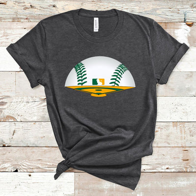 Heather Graphite Tee. Graphic is a green and yellow baseball field The horizon is a baseball with green laces and there is a baseball symbol in yellow and green with a lion in the middle near center field.