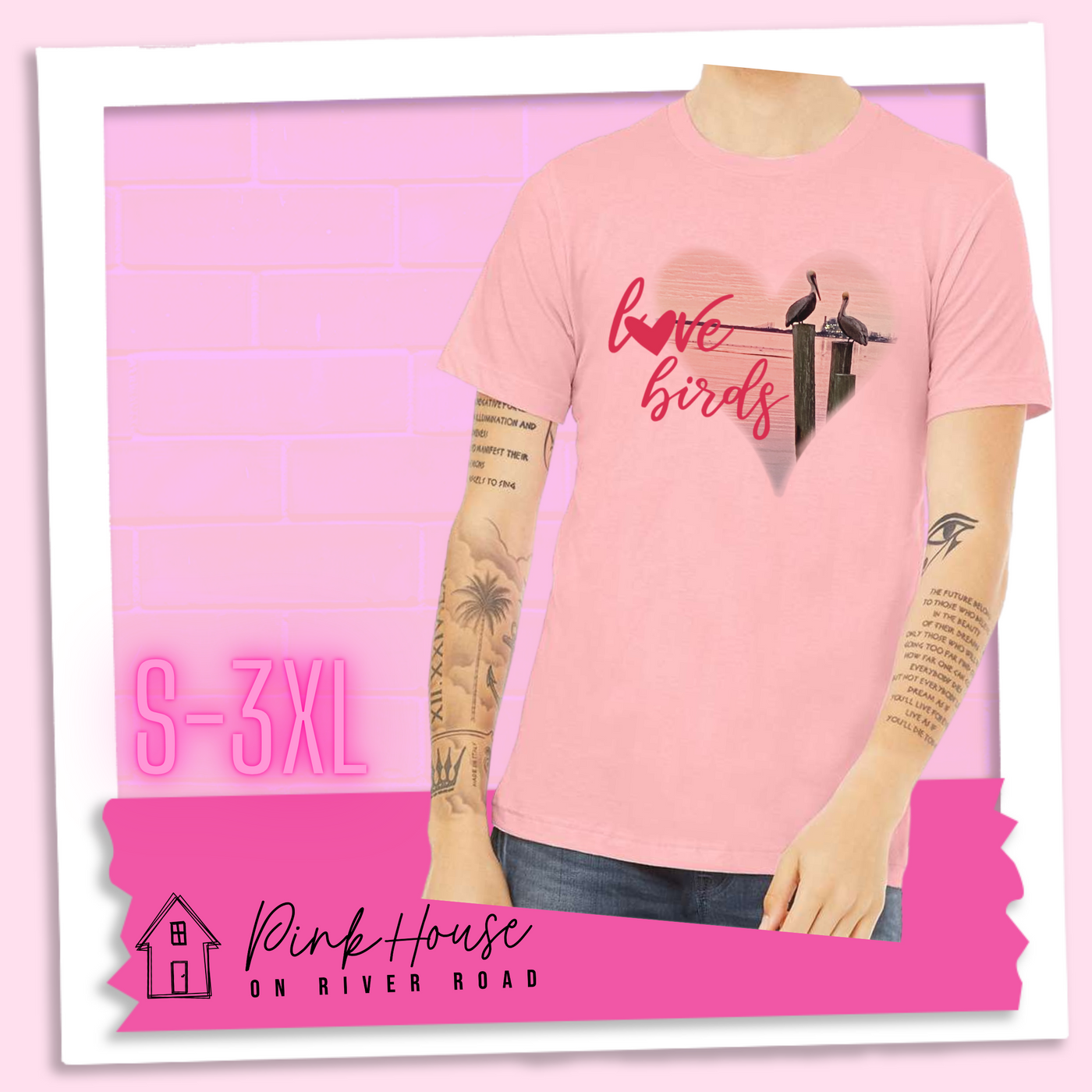 Pink Jersey tee with graphic. Graphic is a pink heart with a photo of some pelicans standing on post in the water. To the left of the heart are the words love birds in a pink cursive font and the O in love has been replaced with a heart.