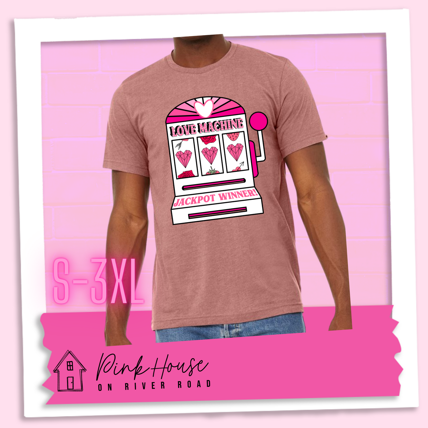 Heather Mauve Tee with a graphic. Graphic is of a white slot machine with pink accents at the top of the slot machine is an arch with different shades of pink and a heart cut out of the middle. Underneath the are are the words Love machine in hot pink with white dots to look like lights. the reels of the slot machines show three geometric hearts. The slot pull has a pink base with a white handle and pink knob on it. Under the reels are the words Jackpot Winner in pink.