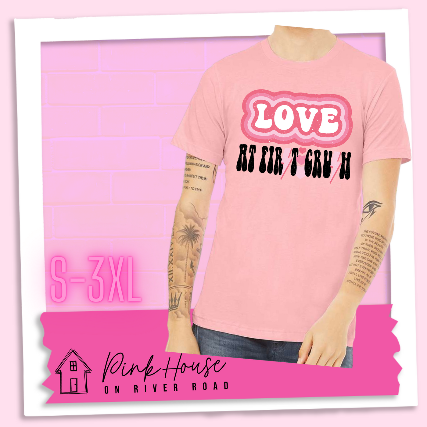 Pink Jersey Tee. The graphic has the word Love in retro bubble letters with differetn colored pink outlines radiating from the word, underneath are the worxs at first in black with the s in first replaced with a pink lightning bolt, then there are three different colored hearts followed by the word crush in the same black font with the S replaced with the same pink lightening bolt.