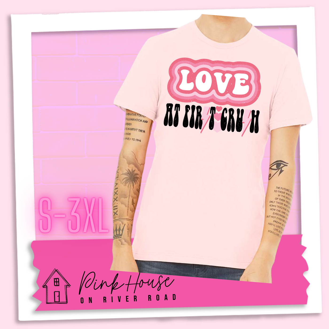 Soft Pink Tee. The graphic has the word Love in retro bubble letters with differetn colored pink outlines radiating from the word, underneath are the worxs at first in black with the s in first replaced with a pink lightning bolt, then there are three different colored hearts followed by the word crush in the same black font with the S replaced with the same pink lightening bolt.