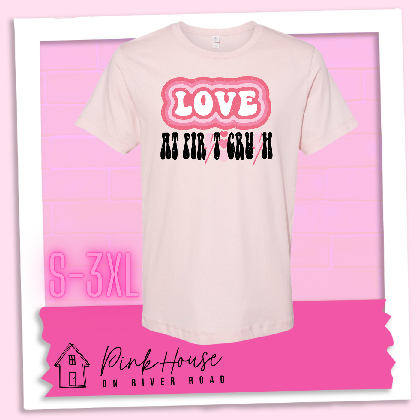 Faded Pink Tee. The graphic has the word Love in retro bubble letters with differetn colored pink outlines radiating from the word, underneath are the worxs at first in black with the s in first replaced with a pink lightning bolt, then there are three different colored hearts followed by the word crush in the same black font with the S replaced with the same pink lightening bolt.