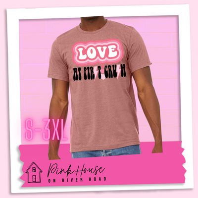 Heather Mauve Tee. The graphic has the word Love in retro bubble letters with differetn colored pink outlines radiating from the word, underneath are the worxs at first in black with the s in first replaced with a pink lightning bolt, then there are three different colored hearts followed by the word crush in the same black font with the S replaced with the same pink lightening bolt.