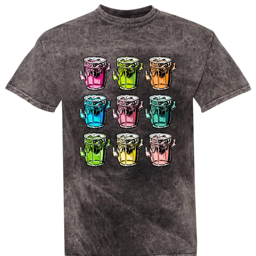A black mineral wash tee with a graphic. Graphic is of 9 margarita glasses, 3 rows of 3, all shaped like cactus with ice cubes, limes and salt on the rim, all 9 glasses are a different color.