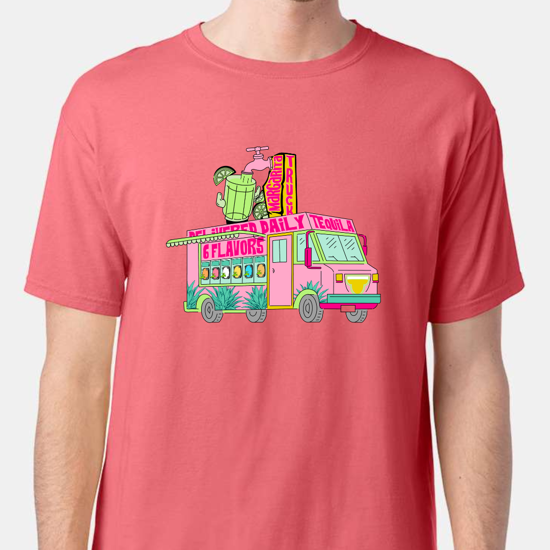 Coral tee. Graphic has a food truck that delivers margaritas. Truck is pink with words that say Delivered Daily Tequila 6 Flavors across the top. The side of the truck has 6 different drink dispensers and the top of the truck has a spot and margarita pitcher.