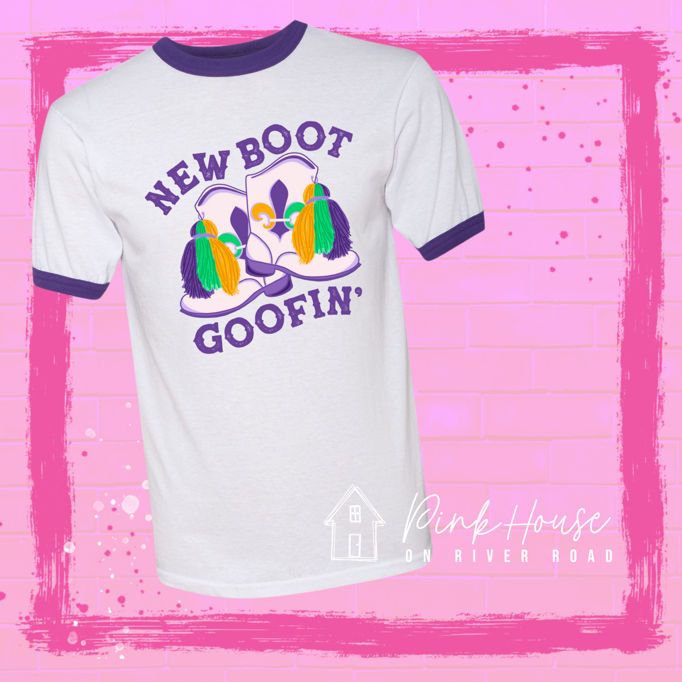A white/purple tee with a graphic. Graphic is of a pair of majorette boots, the boots have a tassel and fleur de lis both in gold, green and purple. the words New Boot are above the boots and the word goofin' is below thee boots the words are in purple.