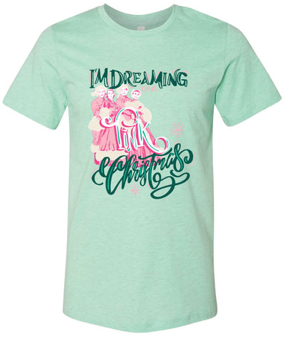 Mint tee with the words Im Dreaming in a green whimsical font underneath there is the wors of a in a pink color there is a graphic of two couples in vintage winter clothing and the word Pink over the couple and the word Christmas at the bottom in the same green font as the words im dreaming
