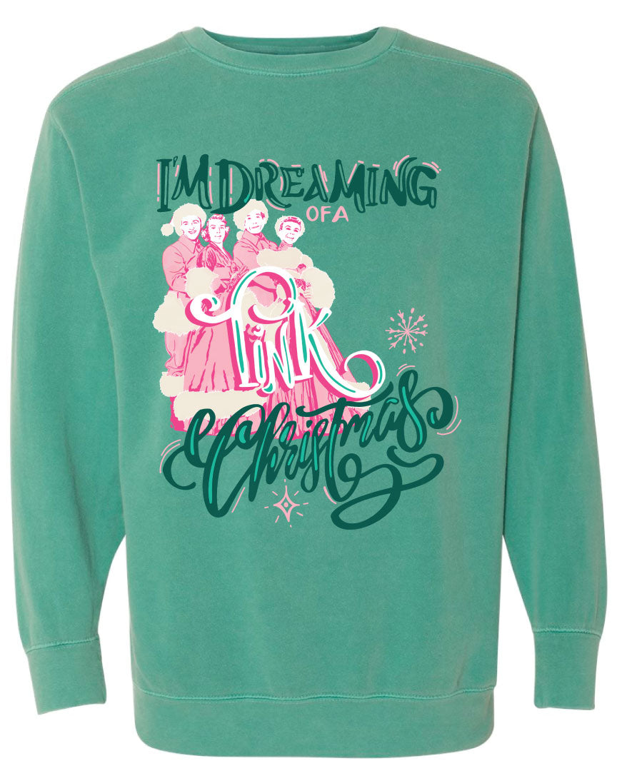 Green sweatshirt with the words Im Dreaming in a green whimsical font underneath there is the wors of a in a pink color there is a graphic of two couples in vintage winter clothing and the word Pink over the couple and the word Christmas at the bottom in the same green font as the words im dreaming