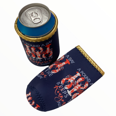 Navy Blue Neoprene Koozie with gold trim. There are three red with white splatter crawfish in alternating directions. There are the same three crawfish on the bottom of the koozie. The text reads a pound a day keeps the rougarux away. Rougaroux is in red cursive all other text is in white.