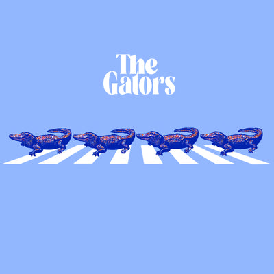 Light Blue Background. Abbey Road cross walk with blue and orange gators walking across with the words "The Gators" in white above.