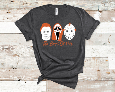 Black tee with Michael mask, Scream Mask and Jason Mask in white and burnt orange with text underneath that reads "The Boys of Fall"