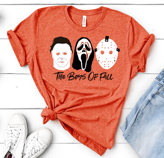 Orange tee with Michael mask, Scream Mask and Jason Mask in white and black with text underneath that reads "The Boys of Fall"