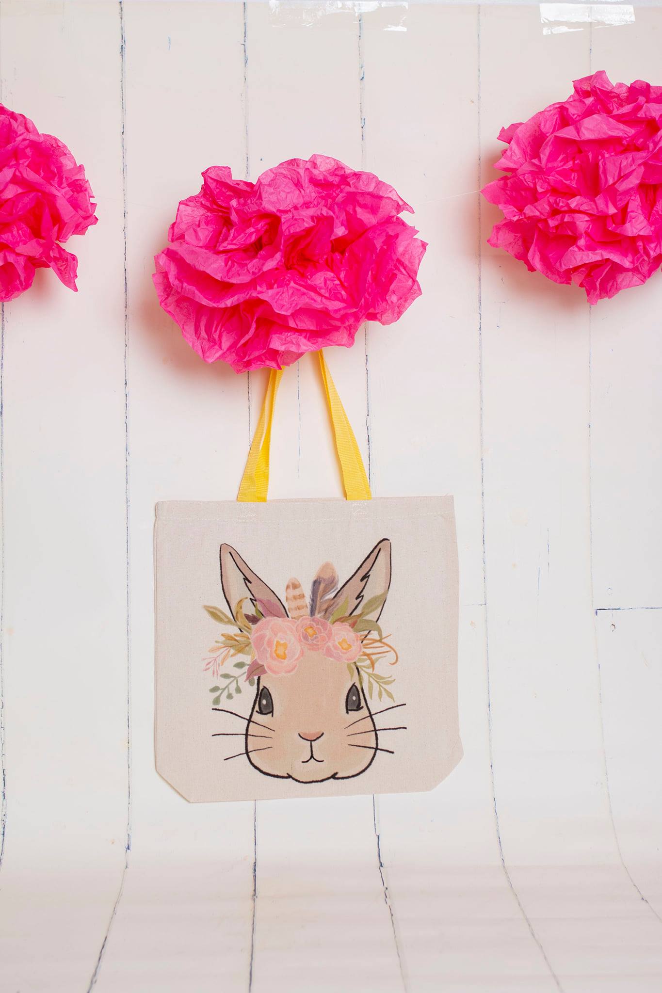 Canvas tote with yellow handles, graphic of a bunny wearing a floral crown 