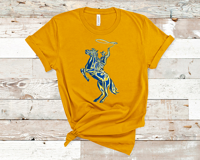 mustard shirt with a graphic of a yellow, blue, and white layered cowboy swinging a lasso on a horse that is standing on its hind legs.