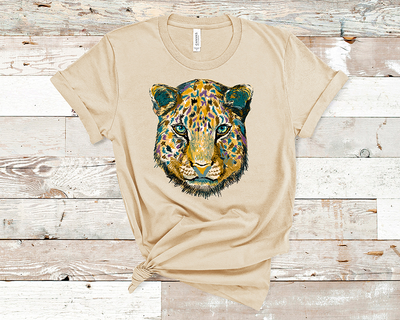 Natural Tan shirt with a graphic of a jaguar layered with blue purple and brown spots.