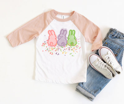 W white raglan with peach sleeves and a graphic with three different neon colored bunny outlines and neon splatters underneath the bunnies
